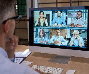 Man at Laptop watching Zoom session